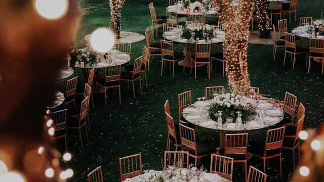 a group of tables and chairs under lights