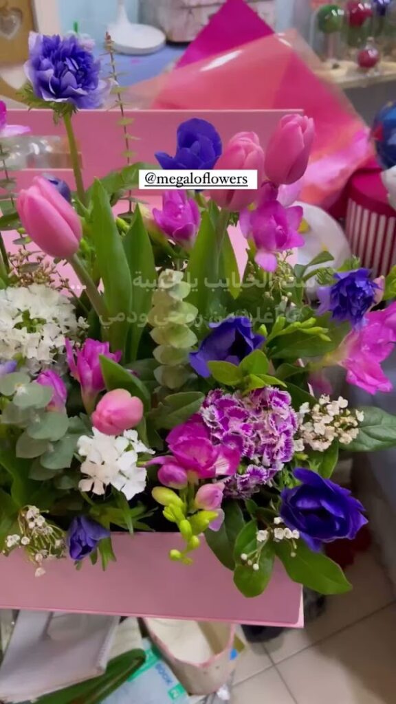 a bouquet of flowers in a pink container