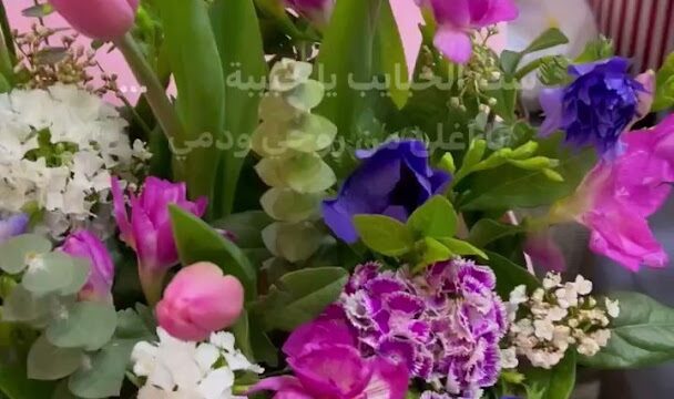 a bouquet of flowers in a pink container