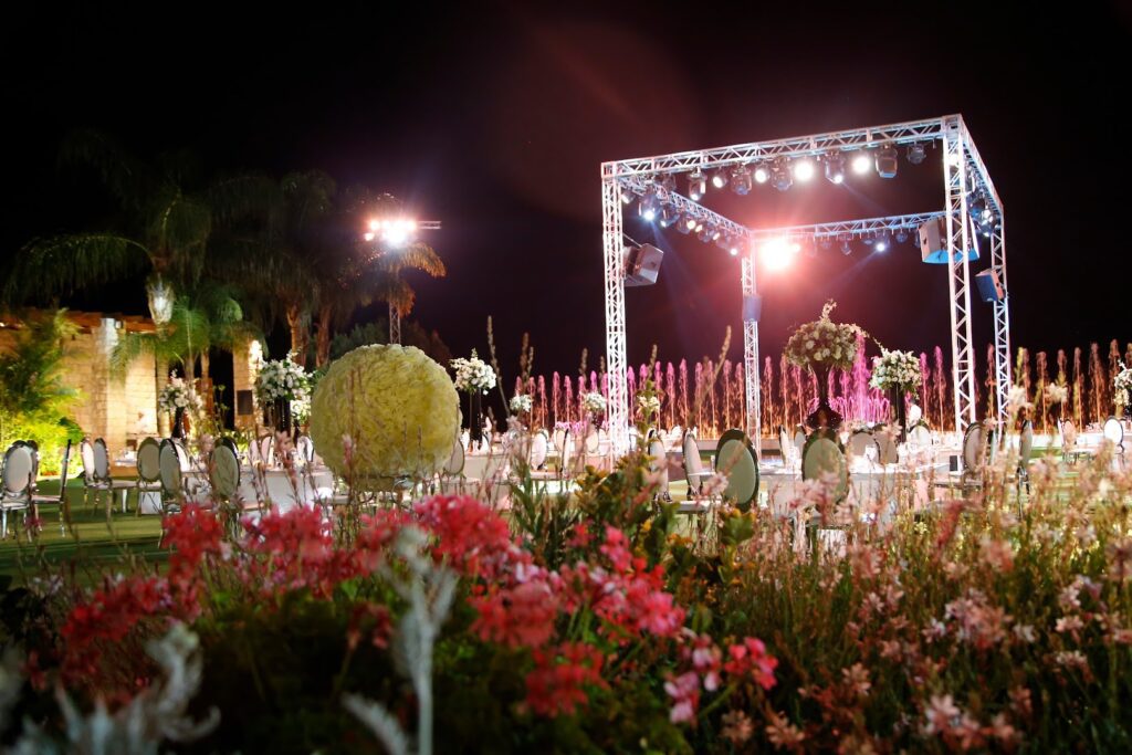 a stage with lights and flowers