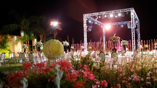 a stage with lights and flowers