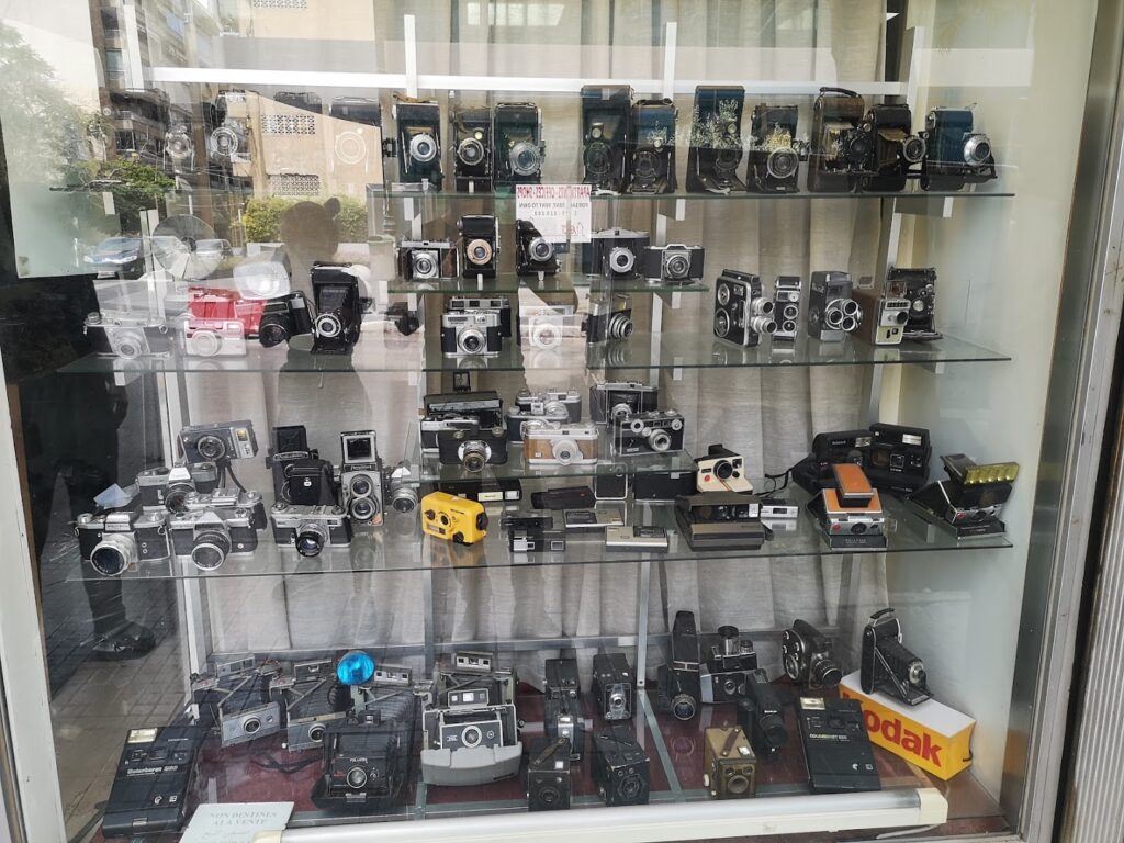 A display of Middle East Photo Center cameras on shelves.