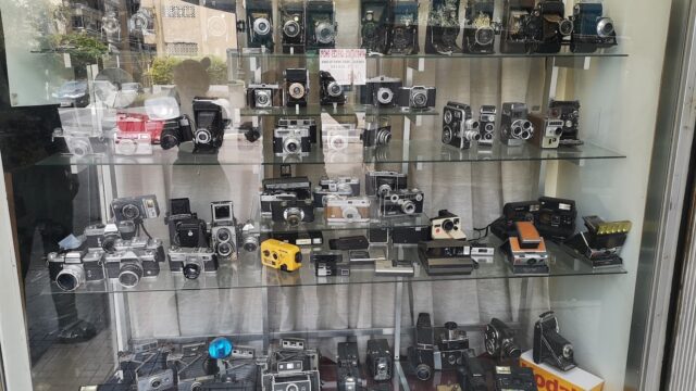 A display of Middle East Photo Center cameras on shelves.