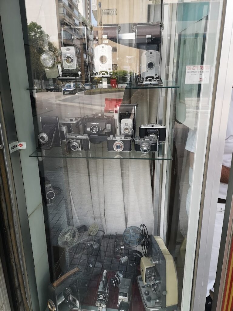 A glass case with a group of cameras showcasing the Middle East Photo Center.