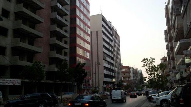 a street with cars and buildings