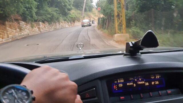 a person driving a car on a road