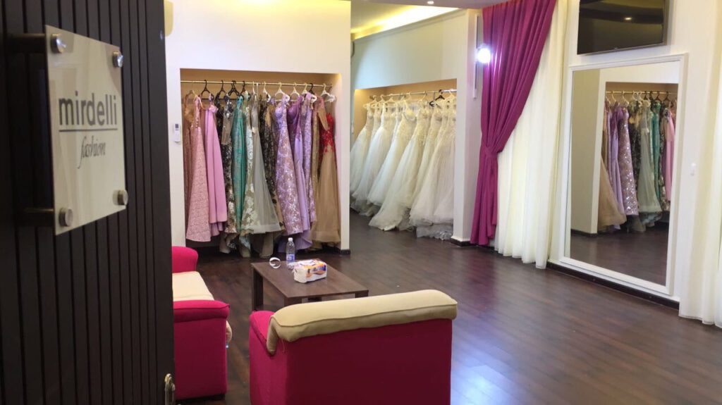 a room with a room with a closet full of dresses