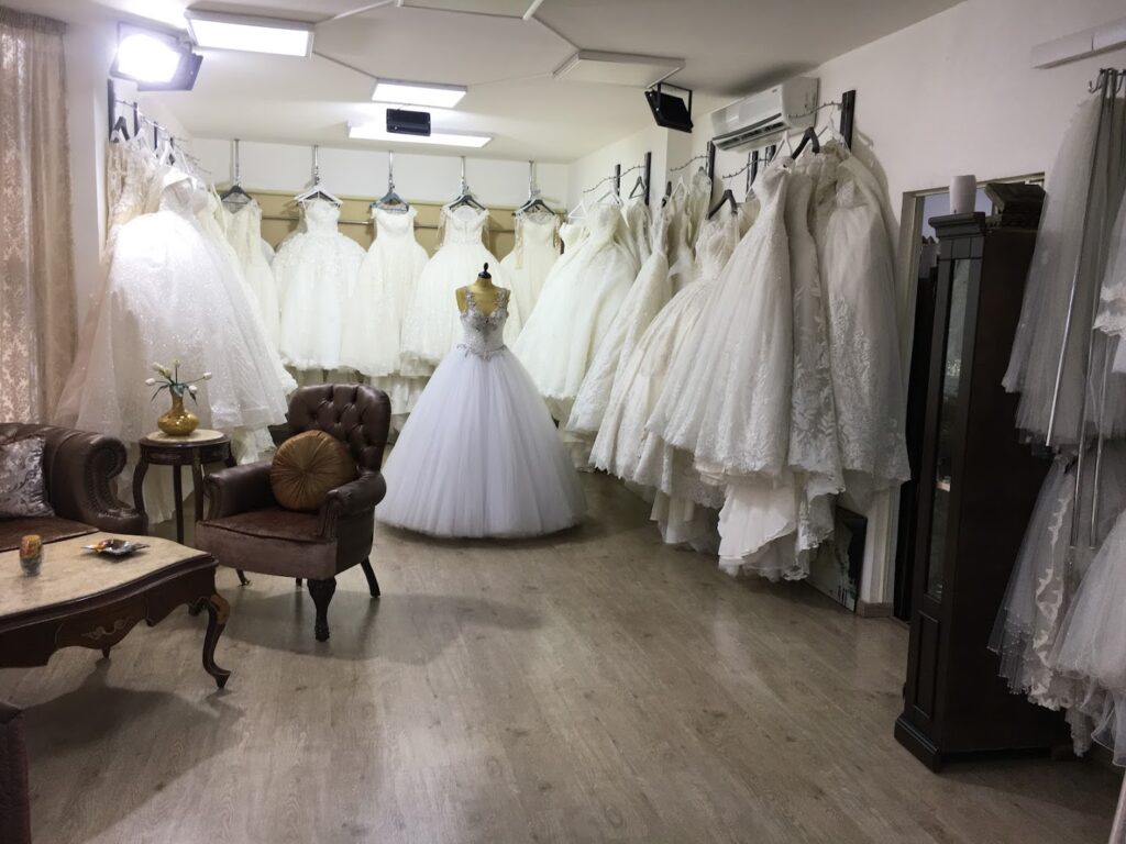 a room with a variety of wedding dresses
