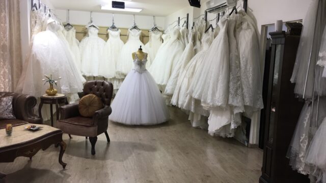 a room with a variety of wedding dresses