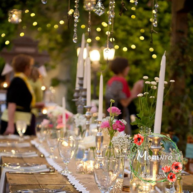 a table with candles and flowers