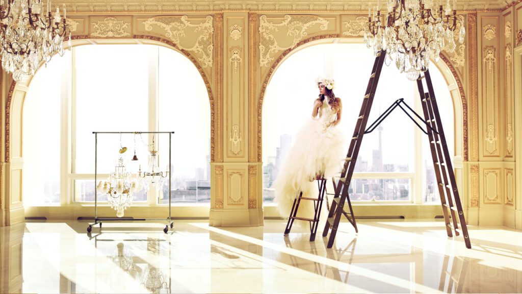 a woman in a wedding dress on a ladder