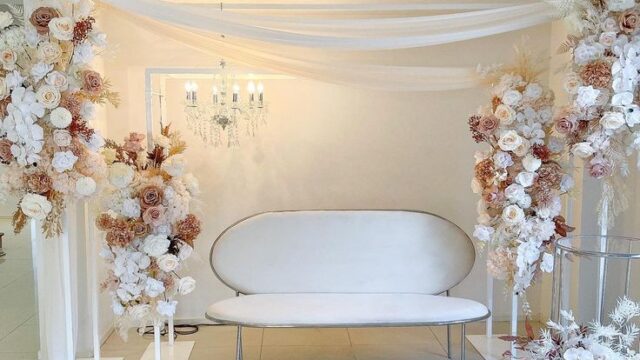 a white and brown floral arrangement in a room