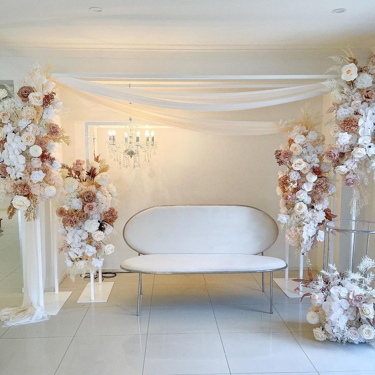 a white and brown floral arrangement in a room