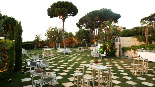 a large checkered lawn with tables and chairs