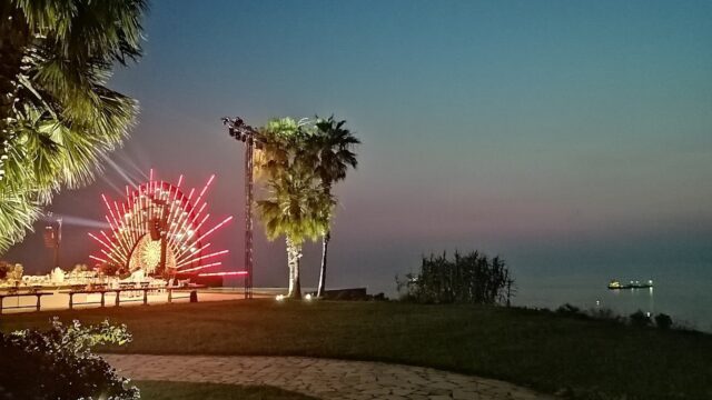 a palm trees and a lighted display at night