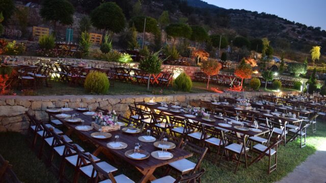 a large outdoor event setting with tables and chairs