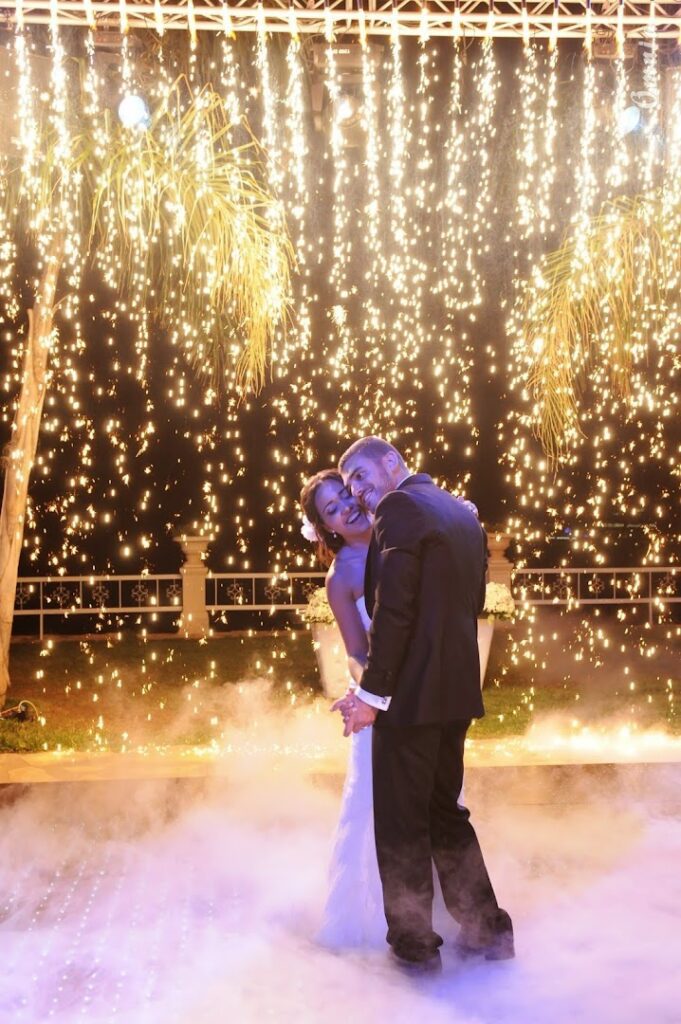 a man and woman in front of a firework display