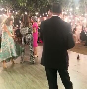 a man in a suit and tie dancing at a party