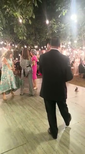 a man in a suit and tie dancing at a party
