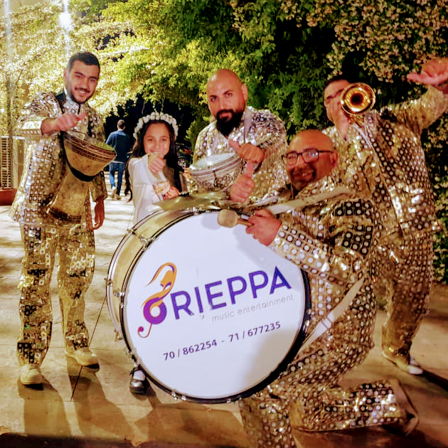 a group of people wearing shiny clothing