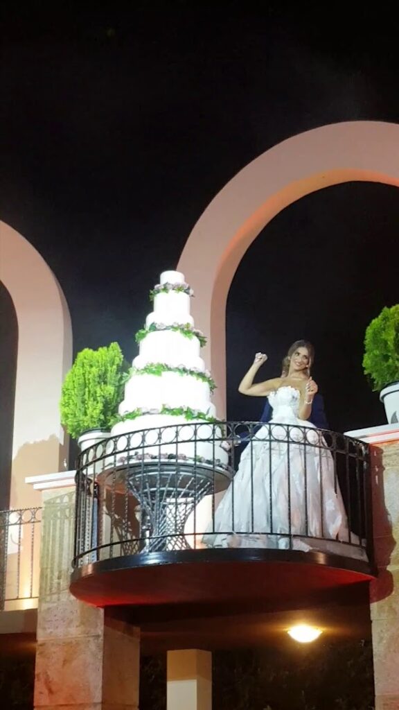 a woman in a wedding dress on a balcony