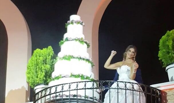 a woman in a wedding dress on a balcony