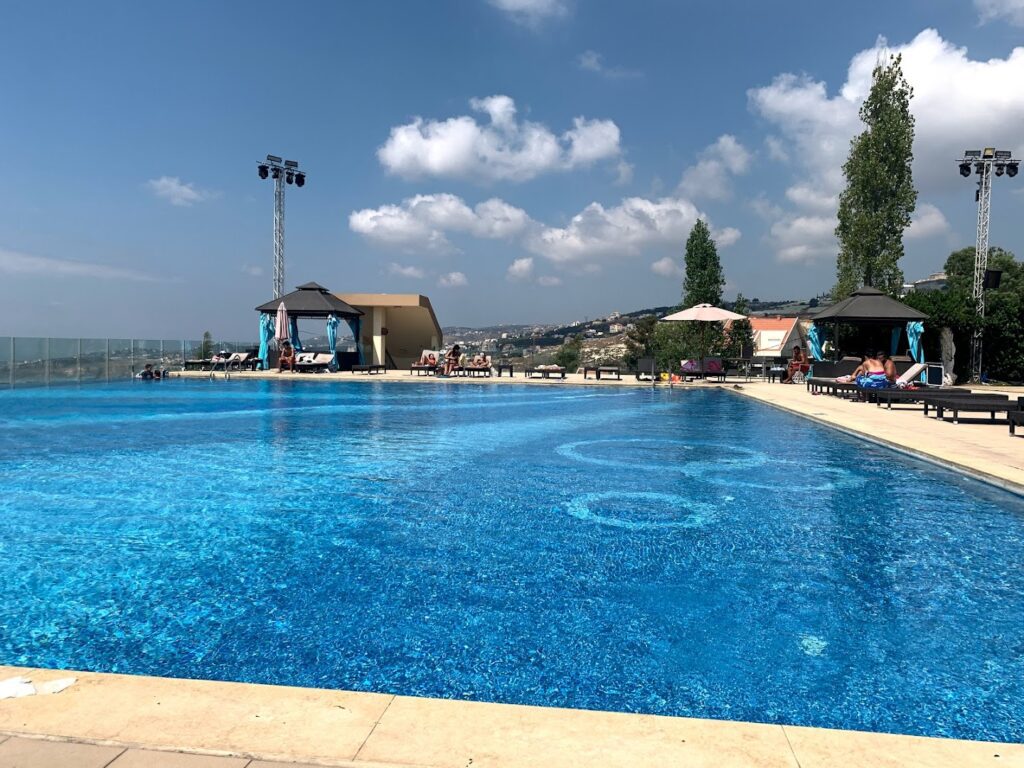 a pool with people sitting around it