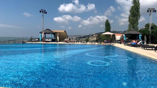 a pool with people sitting around it