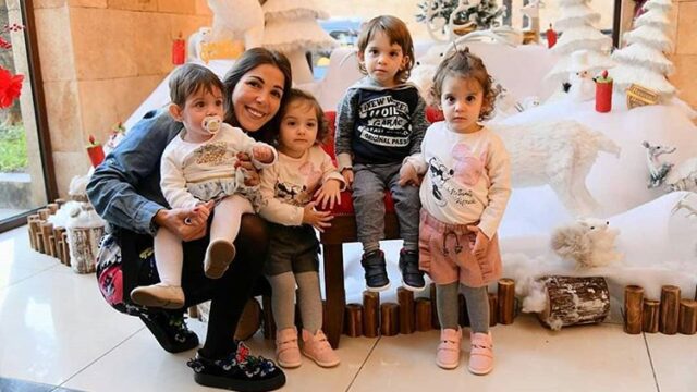 a woman and several children posing for a picture