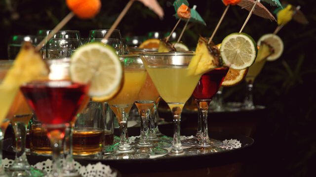 a group of glasses with drinks on them