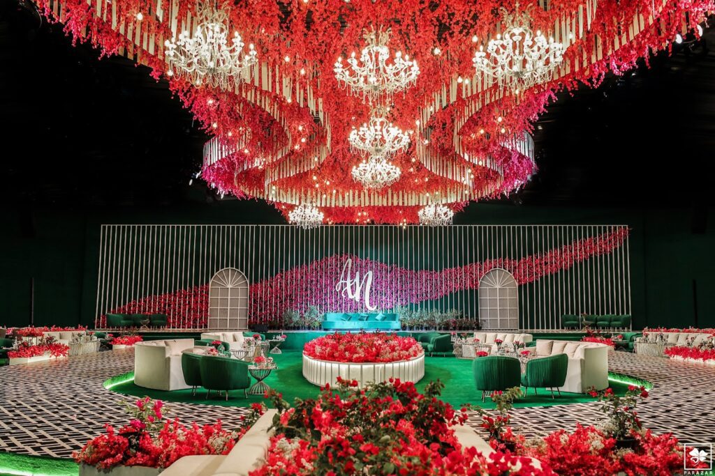 a large room with red flowers and a chandelier