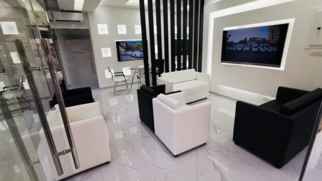 a room with white furniture and a tv