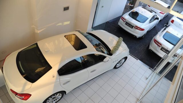 a white car parked in a showroom