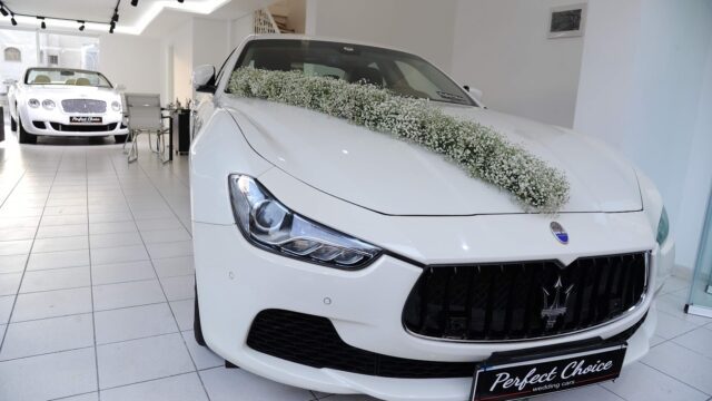 a white car with flowers on the hood