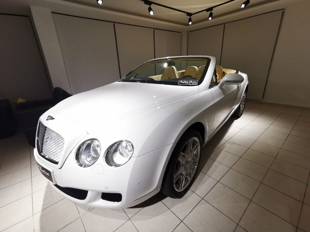 a white convertible car in a room