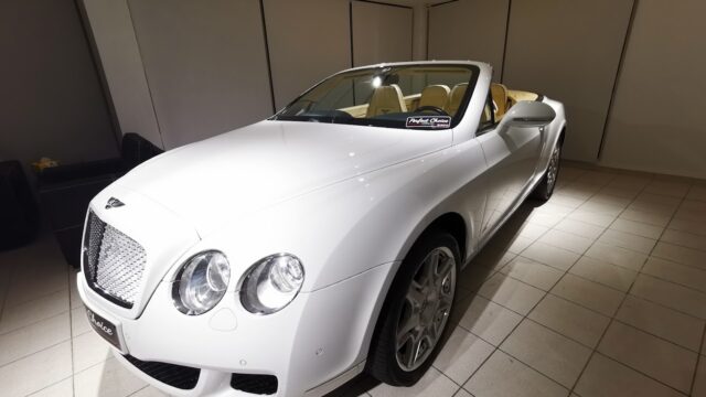 a white convertible car in a room