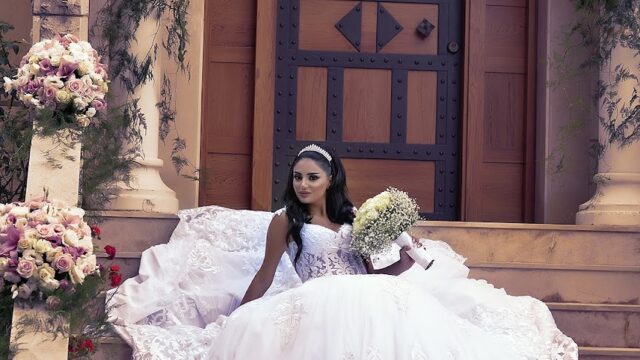 a woman in a wedding dress sitting on stairs