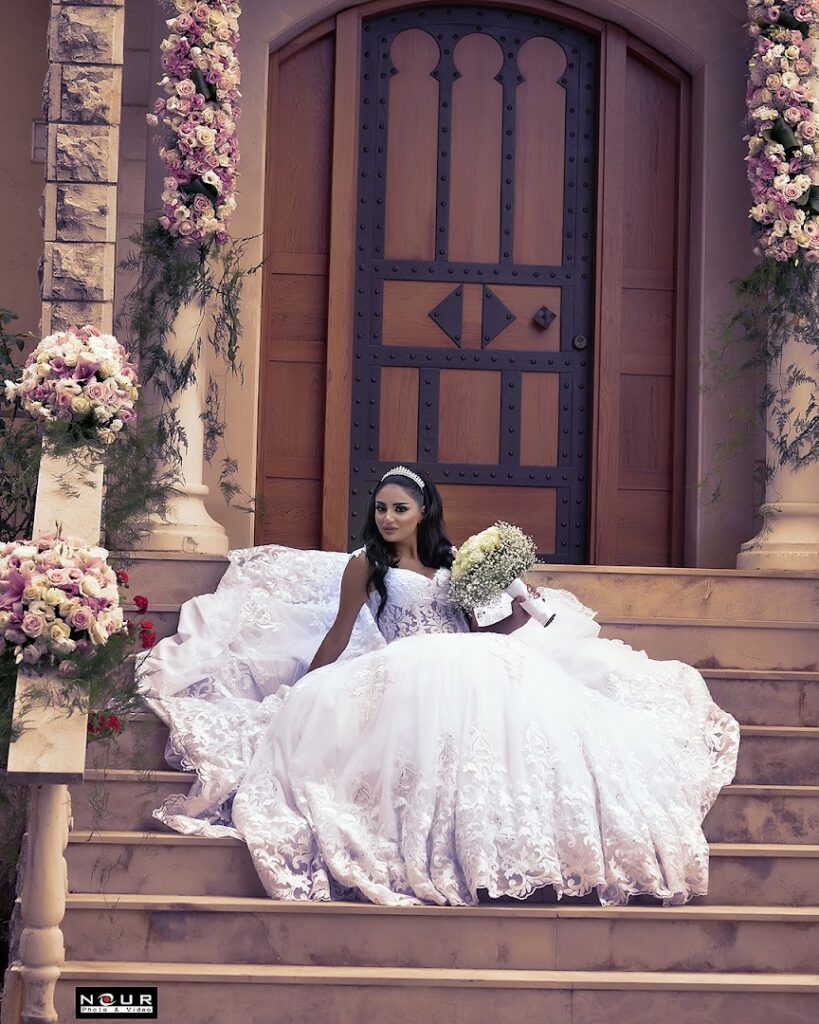 a woman in a wedding dress sitting on stairs