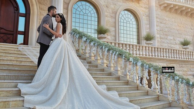 a man and woman in a wedding dress on stairs