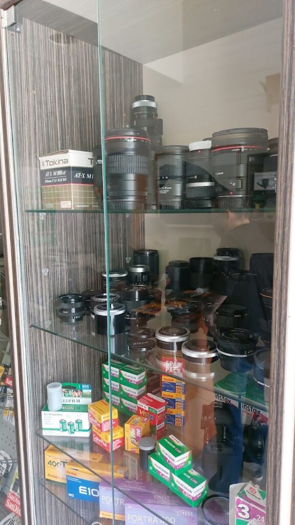 A glass cabinet with camera lenses showcasing the latest collection of "Photo palladium" equipment.