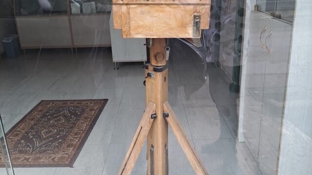 a wooden camera on a tripod