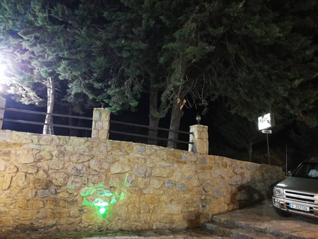 a car parked on a stone wall with a green light
