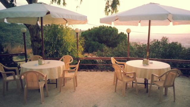 a table and chairs under umbrellas