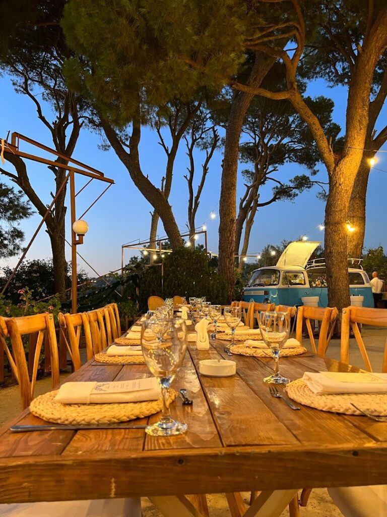 a table set for dinner with wine glasses and plates on it