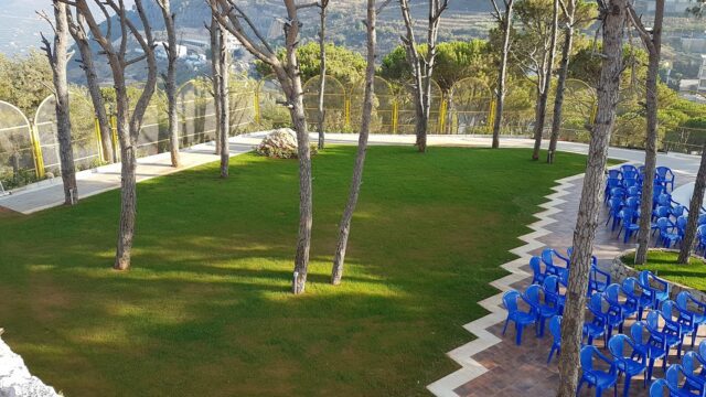 a group of blue chairs in a park