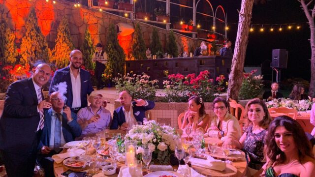 a group of people sitting around a table