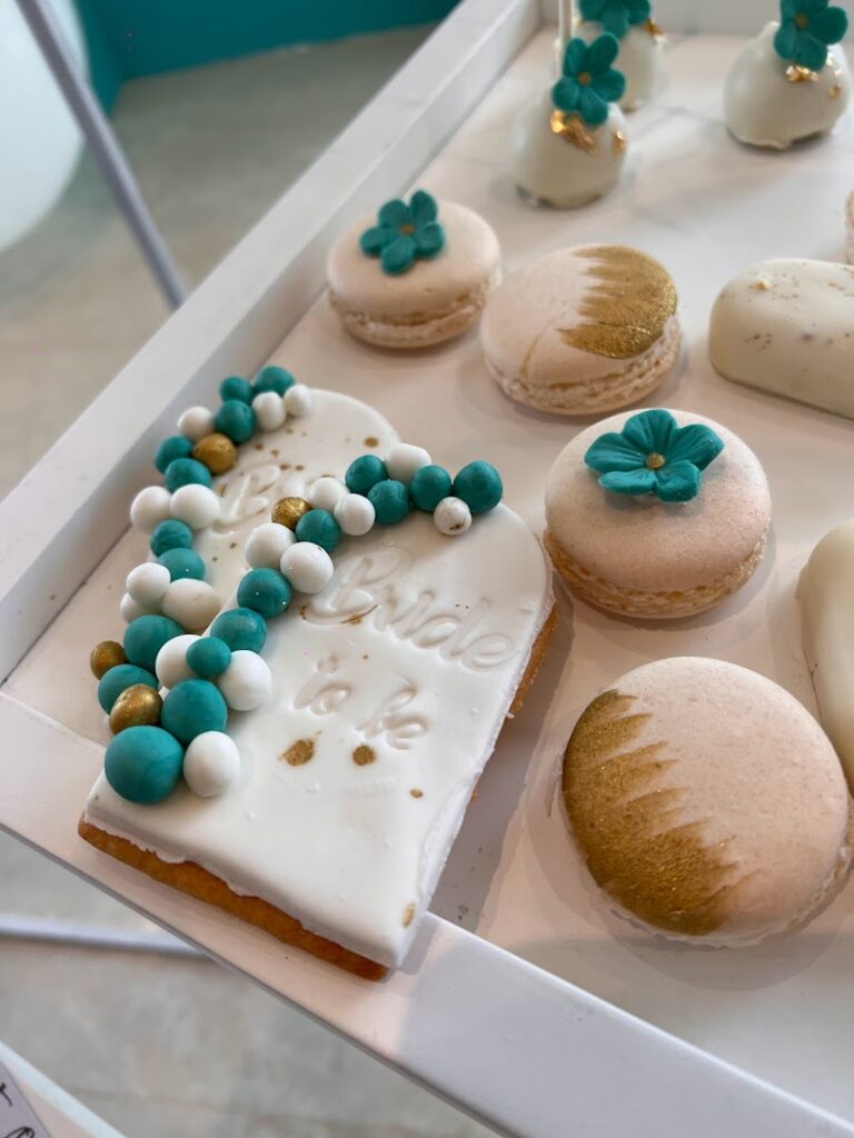 a white tray with cookies and blue and gold decorations