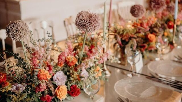 a table set with flowers and plates