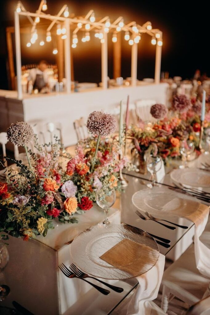 a table set with flowers and plates