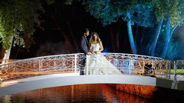 a man and woman standing on a bridge